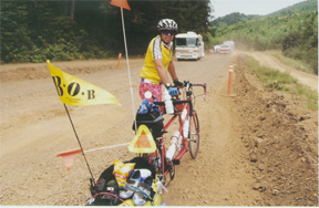 Riding on the side of the road while cars pass the other direction